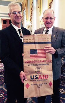 John Didion, CEO of Didion Milling, a Johnson Creek, Wis., firm, poses with House Agriculture Committee Chairman Michael Conaway, R-Texas, with an example of the bags in which U.S. food aid is distributed.